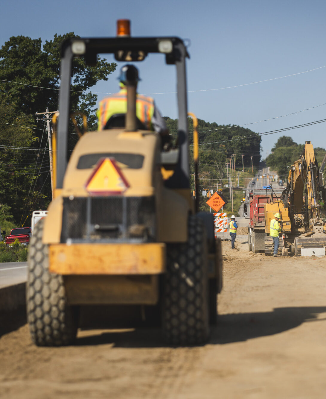 Road construction with heavy machinery moving dirt 